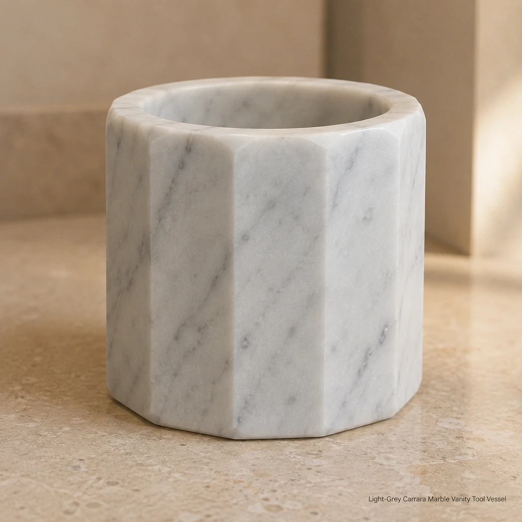 Satin Carrara brush cup on beige limestone vanity, low macro view emphasizing faceted walls and thick rim.