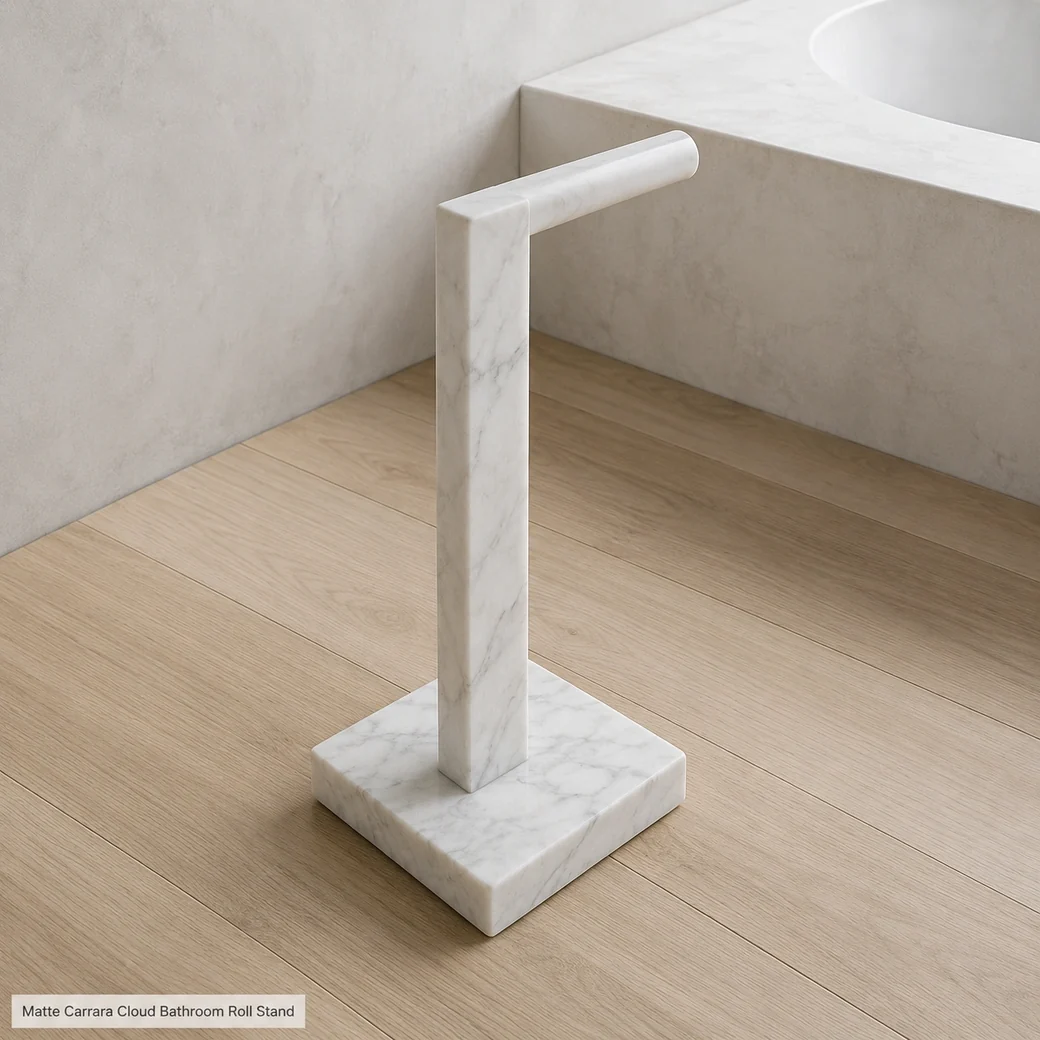Cloud white Carrara toilet paper dispenser in microcement bath, high diagonal view showing top profile and base.