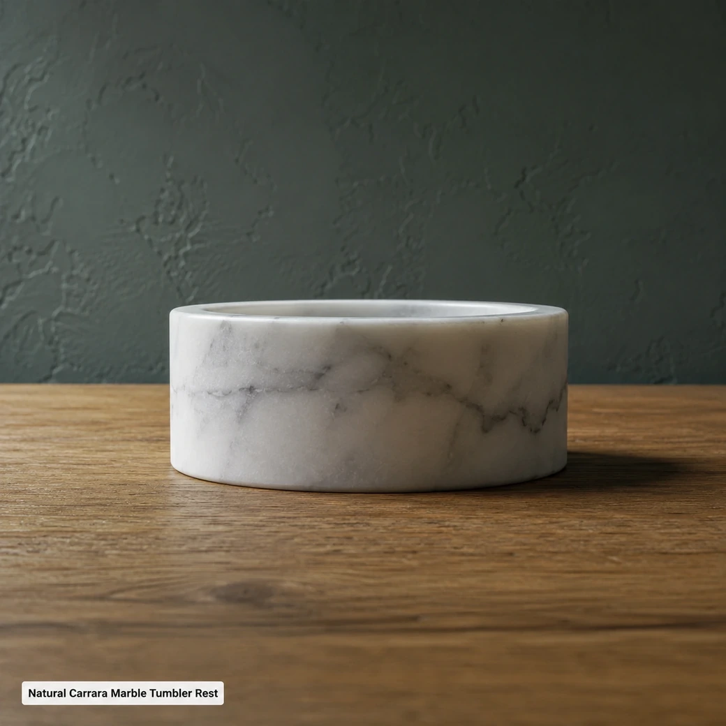 Side-elevation Carrara cup rest on oak with smoky grey veins, rounded rim and honed-satin finish.