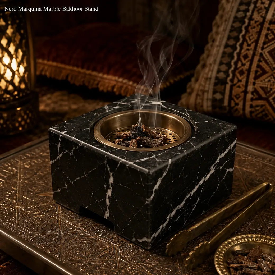 Nero Marquina bakhoor stand with heat-safe incense burner, bakhoor chips, tongs and a light trail of smoke.