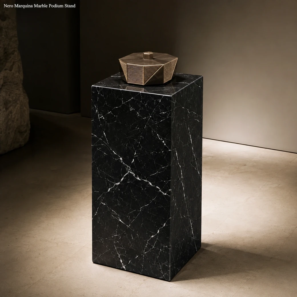 Nero Marquina podium stand displaying a centred sculpture in a minimalist contemporary gallery.