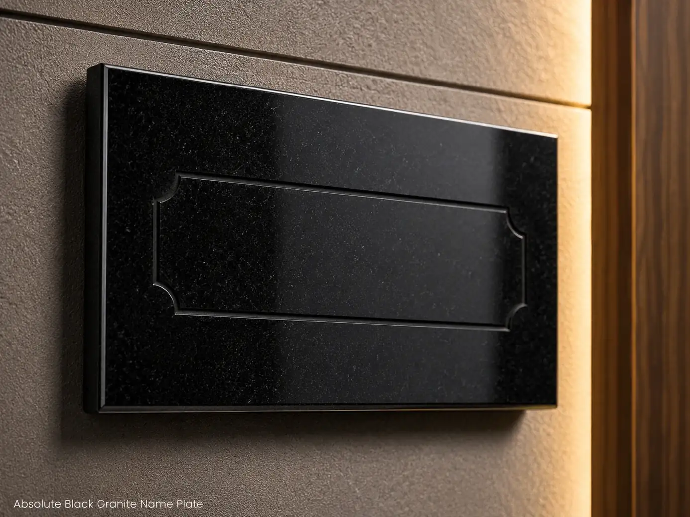 Mirror-polished Absolute Black granite name plate with concealed wall mounting and engraved personalization area