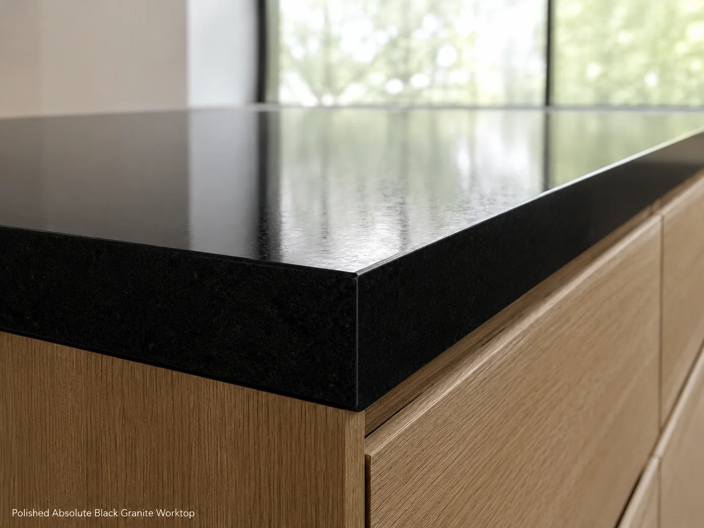 Absolute Black granite worktop installed on matte oak and photographed at countertop edge level