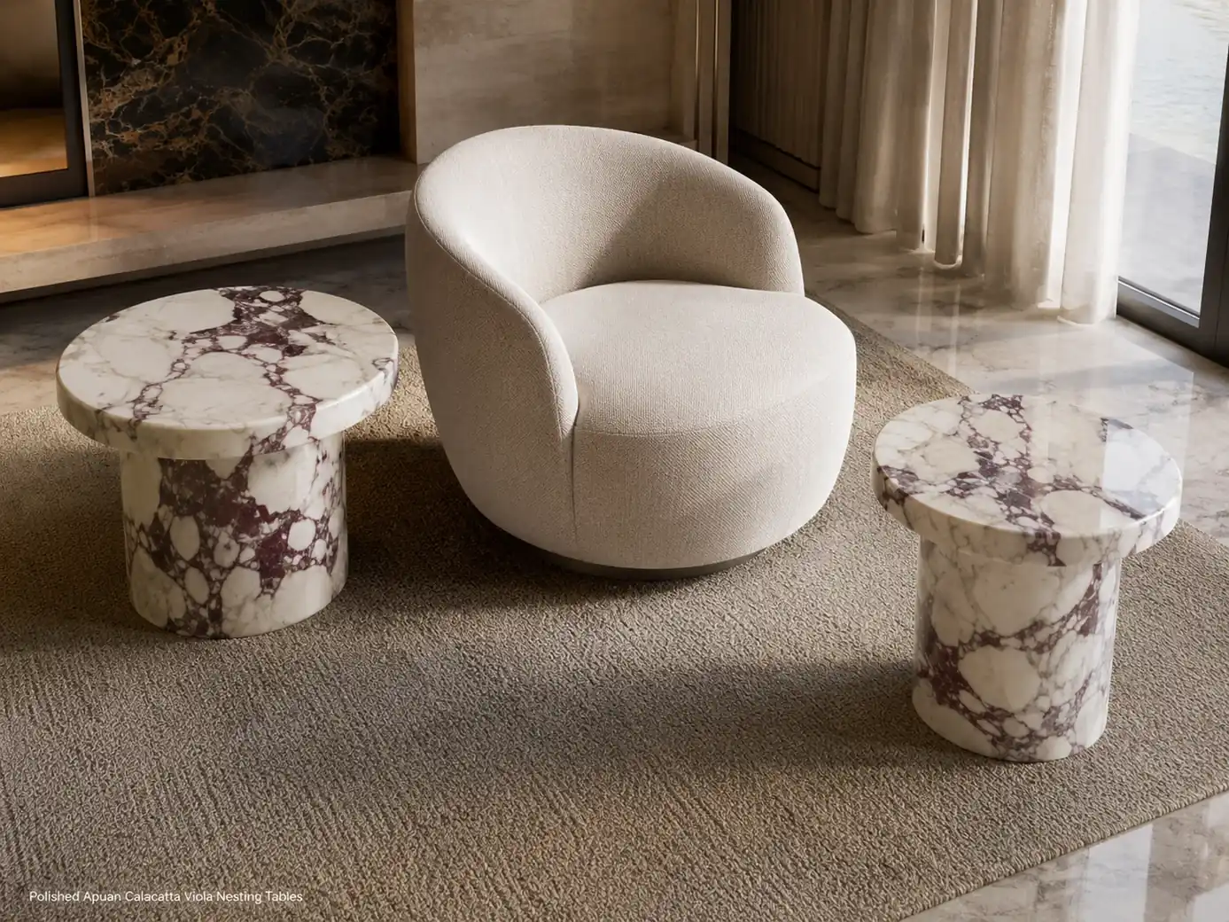 Two polished Calacatta Viola nesting tables separated around a curved chair in a bright sitting area