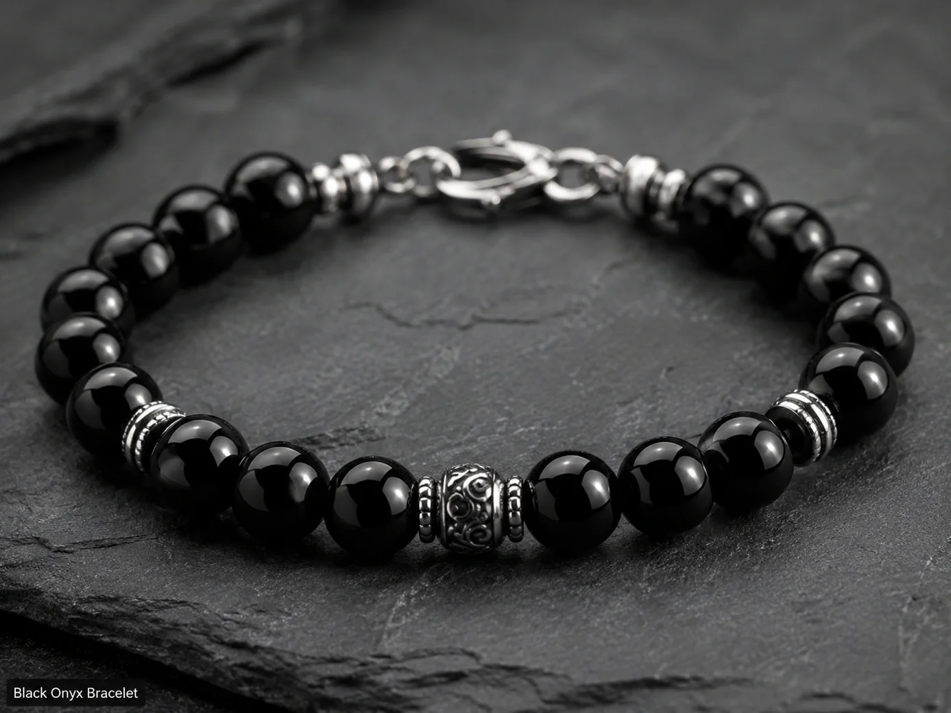 Polished black onyx bracelet with glossy jet-black chalcedony beads photographed on a premium dark surface