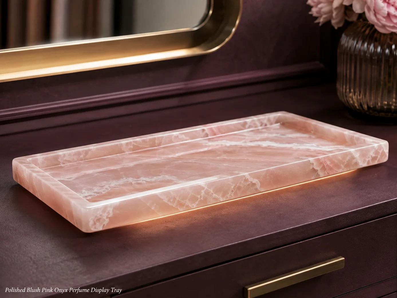 Low-level Pink Onyx perfume tray on dark plum vanity, showing blush translucency, white bands and polished edges.