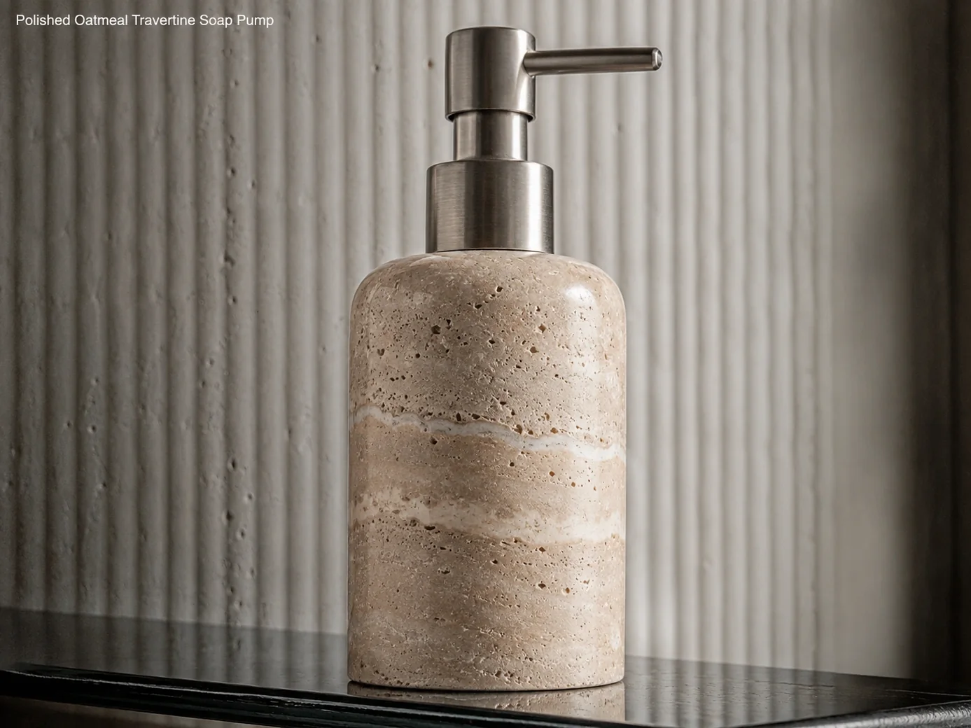 Polished oatmeal travertine soap pump photographed low on smoked glass against a ribbed wall