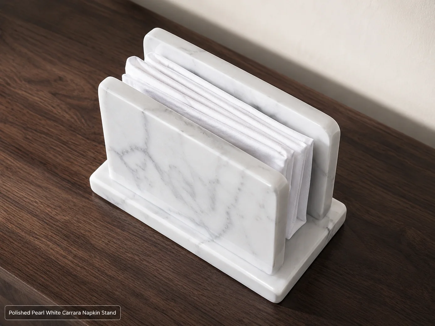 Pearl-white Carrara napkin stand viewed from above on a dark walnut dining console