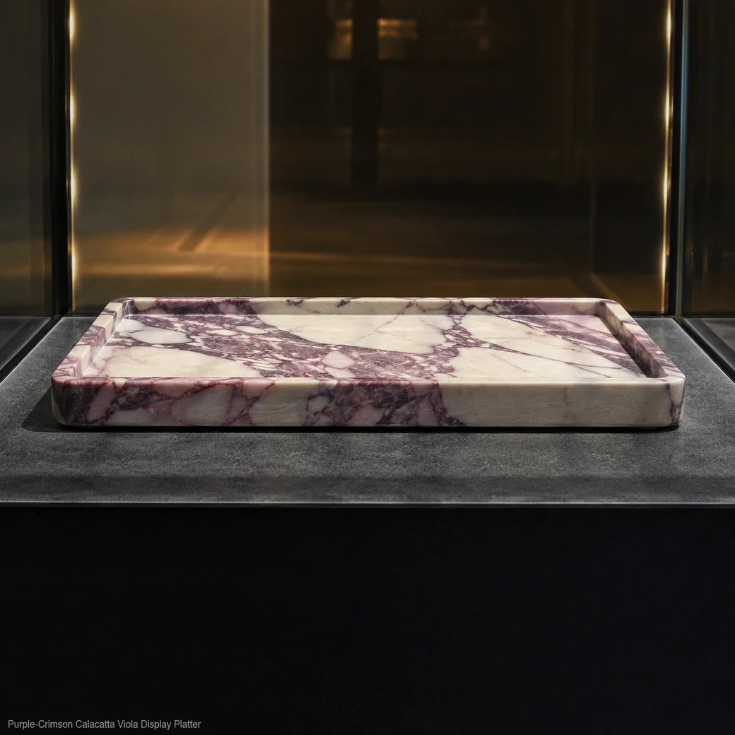 Purple-crimson Calacatta Viola display tray in glass niche, low edge view showing brushed texture and dramatic veins.