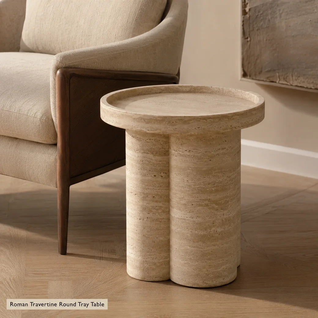 Roman Travertine round tray table in classic warm beige with brushed-honed texture and sculptural base.