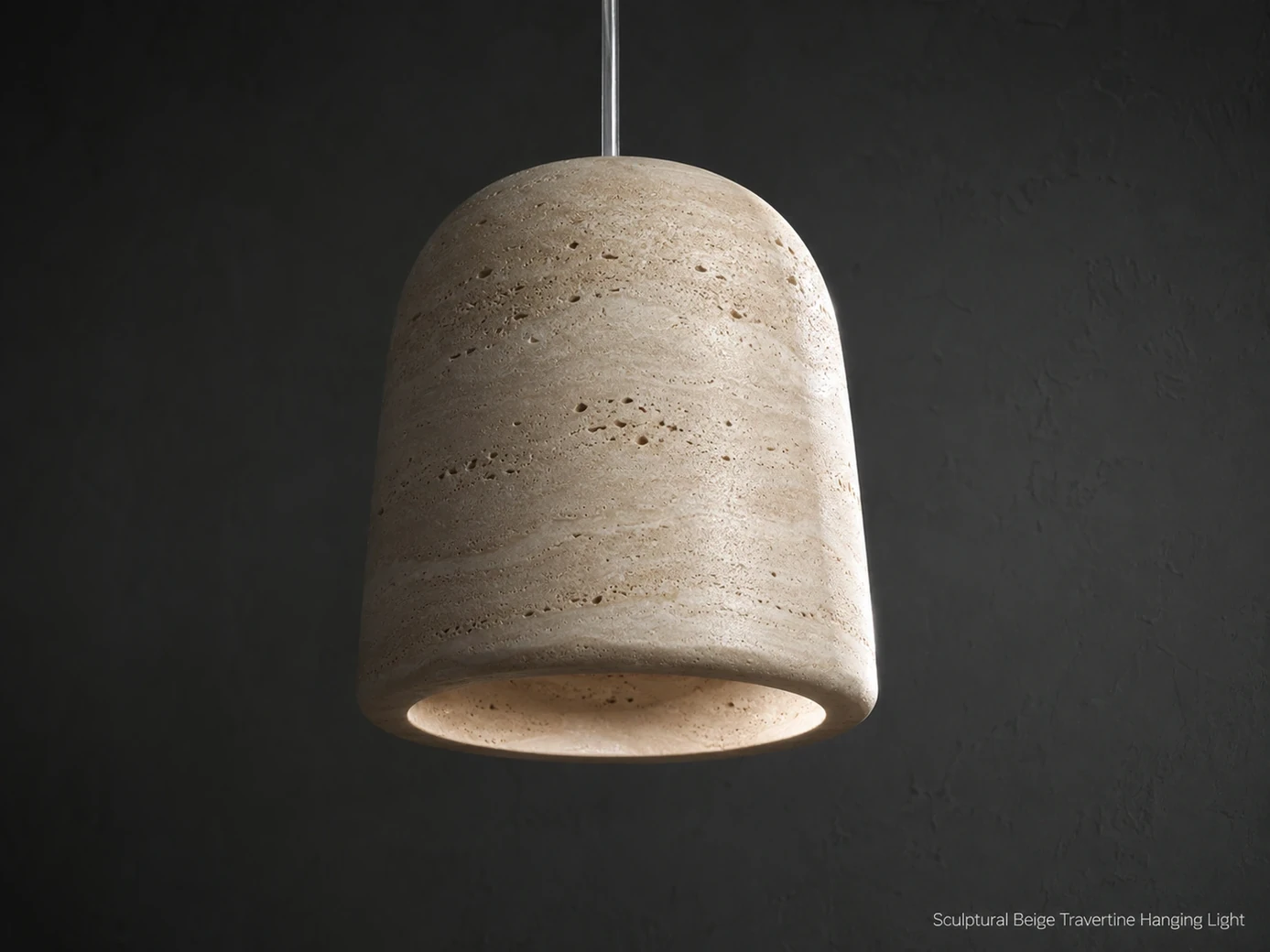Brushed travertine pendant viewed from below against a charcoal wall with the lamp switched off