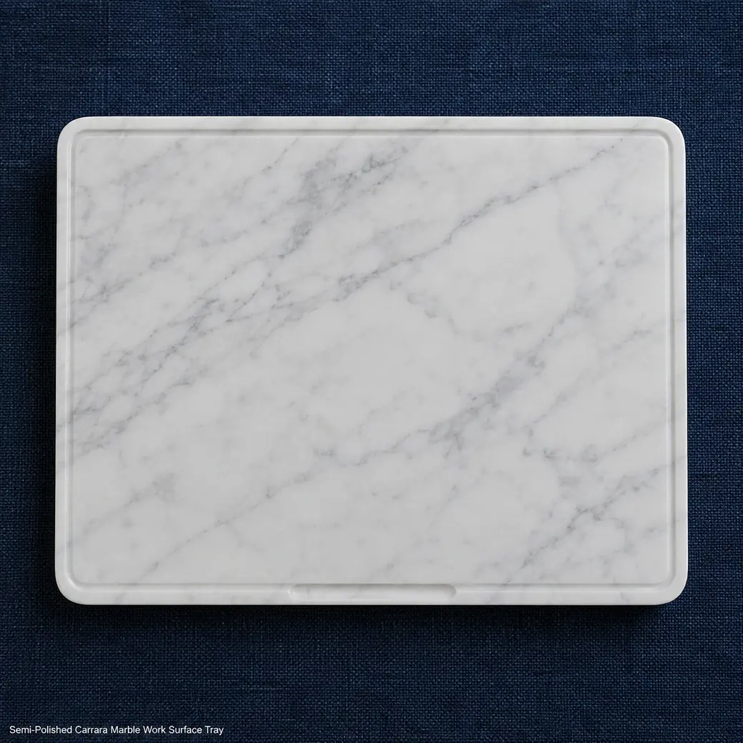 Overhead Carrara laptop tray on navy textile with delicate veining, low border and semi-polished finish.