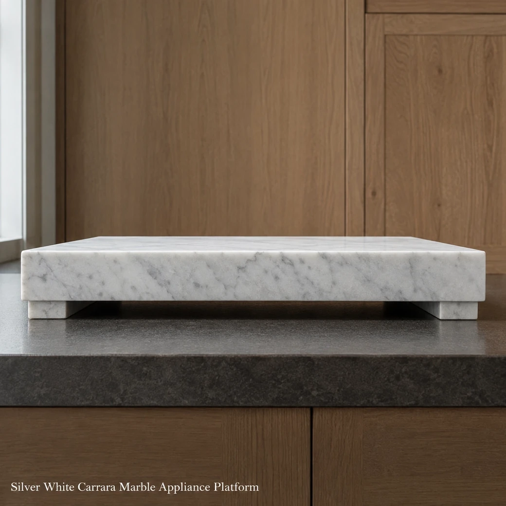 Silver white Carrara appliance platform on a dark worktop, very low end view showing slab height and shadow gap