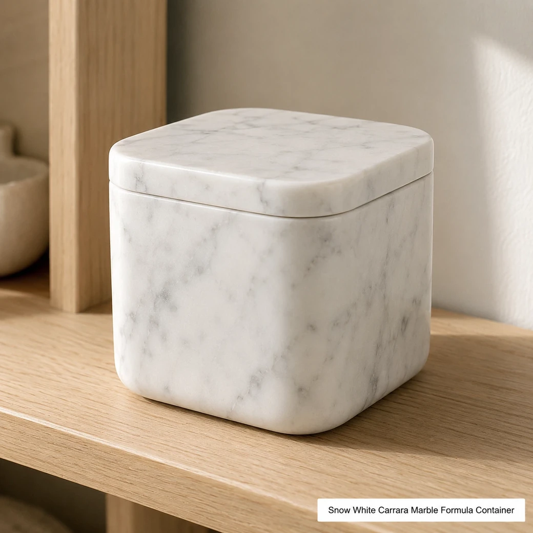 Snow white Carrara formula container on a pale oak nursery shelf, closed and viewed from a low three-quarter angle
