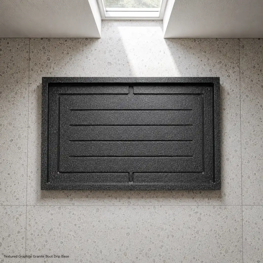 Overhead graphite granite shoe tray on terrazzo with drainage channels and textured Anzano finish.