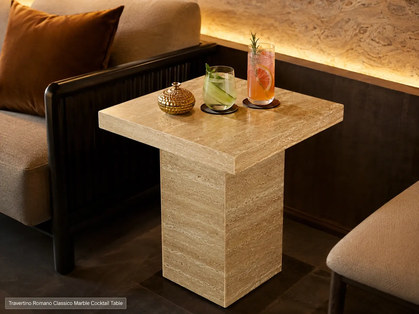 Polished Travertino Romano cocktail table beside lounge seating with two drinks resting on coasters.