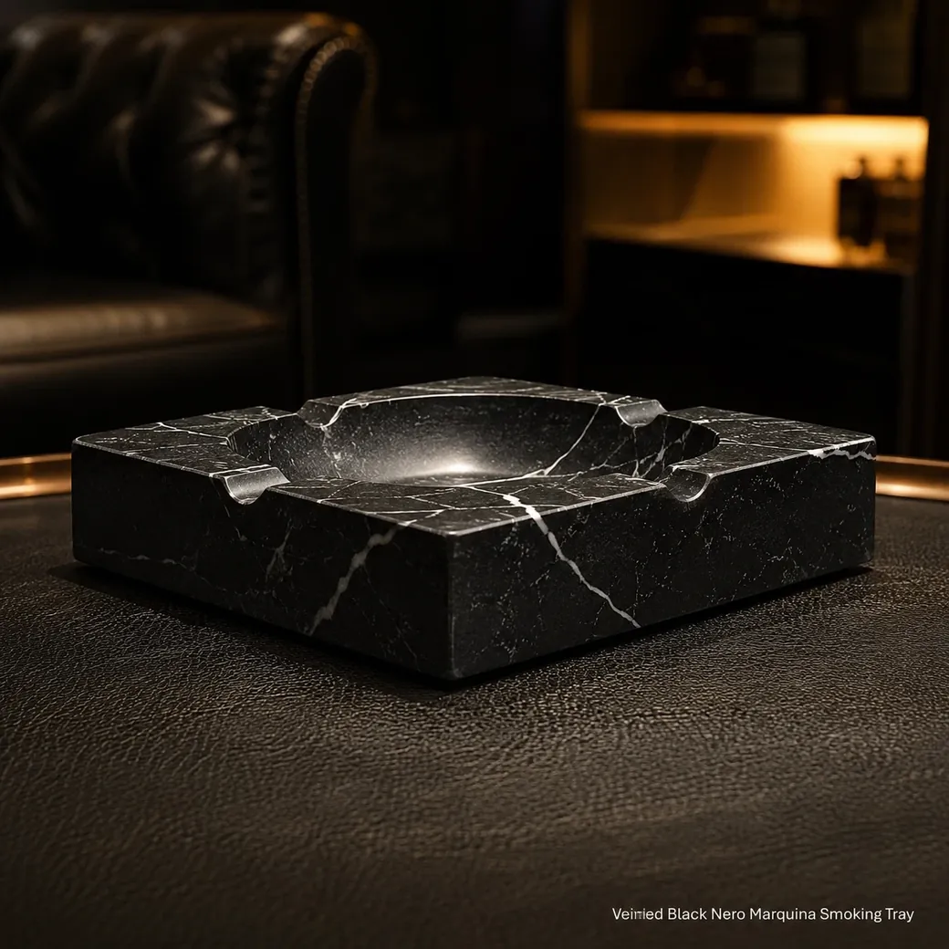 Nero Marquina smoking tray on dark leather table, low side profile showing white veins and Brosso Vecchio texture.