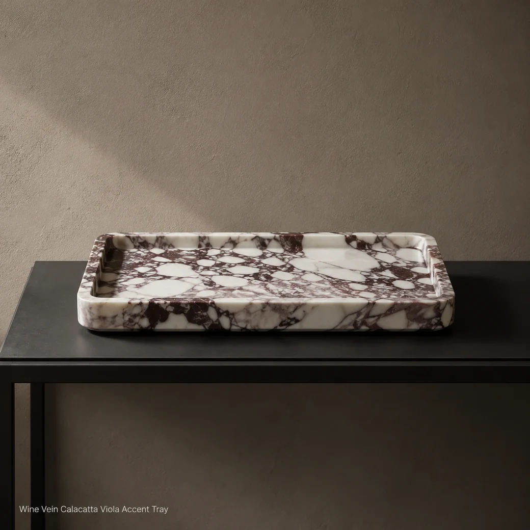 Calacatta Viola accent tray on black console, low frontal view highlighting wine veining and hand-honed texture.